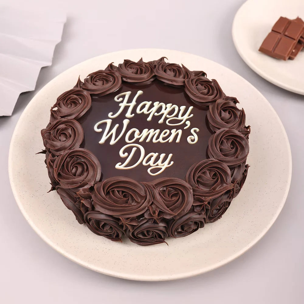 Women's Day chocolate cake with rose-shaped frosting and 'Happy Women's Day' message