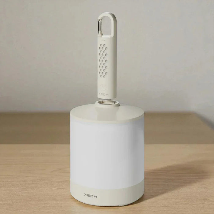 White cleaning tool with a handle on a wooden surface