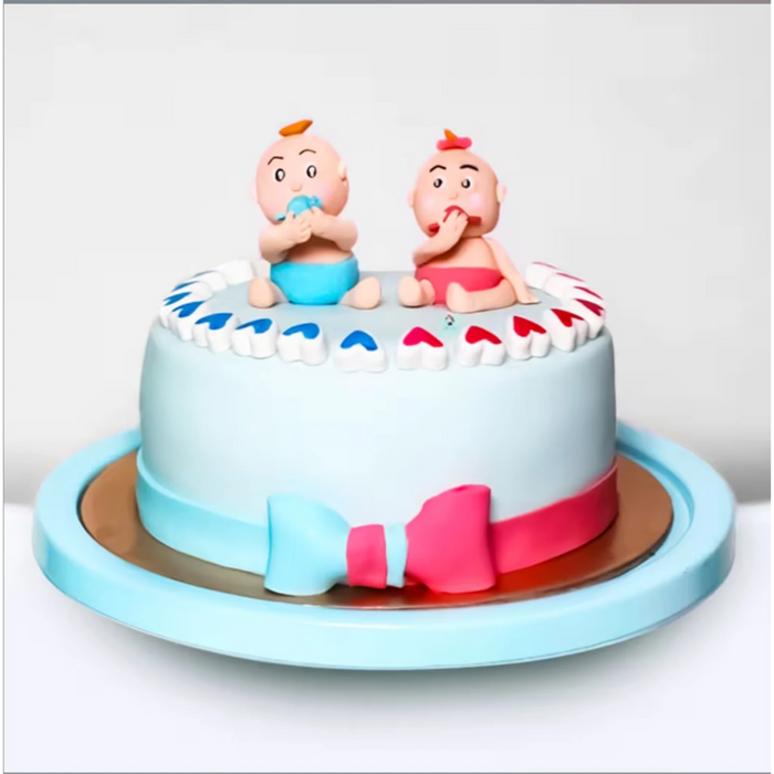 Cute baby shower themed cake with baby figurines on top