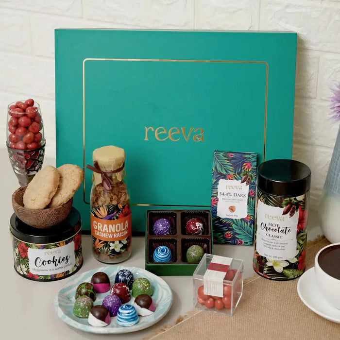 Graceful Indulgence Hamper: Luxury Chocolate Delight gift set with cookies, bonbons, granola, and hot chocolate in a teal box, ideal for festive gifting.
