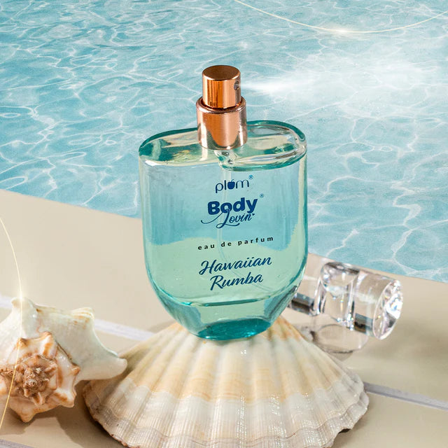 Hawaiian Rumba Eau de Parfum 50ml bottle with tropical beach vibe, placed on seashells beside a pool, ideal for refreshing summer scent.