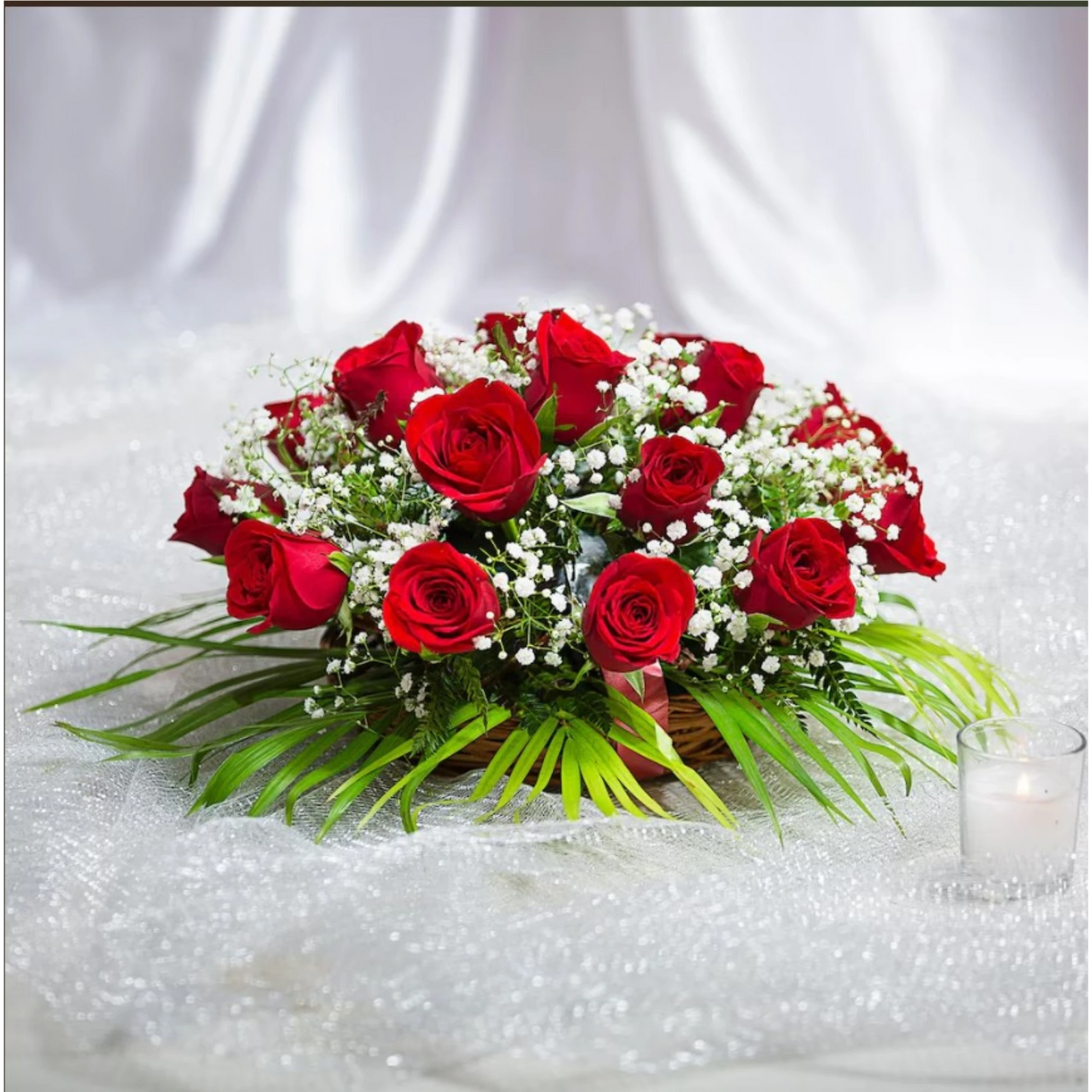 Red roses bouquet with white baby's breath flowers and green leaves