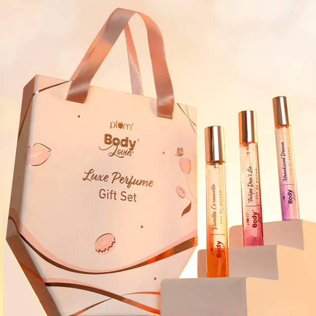Tonka Bella Luxe perfume gift set displayed with three travel-size fragrances and a stylish pink gift bag, perfect for women.