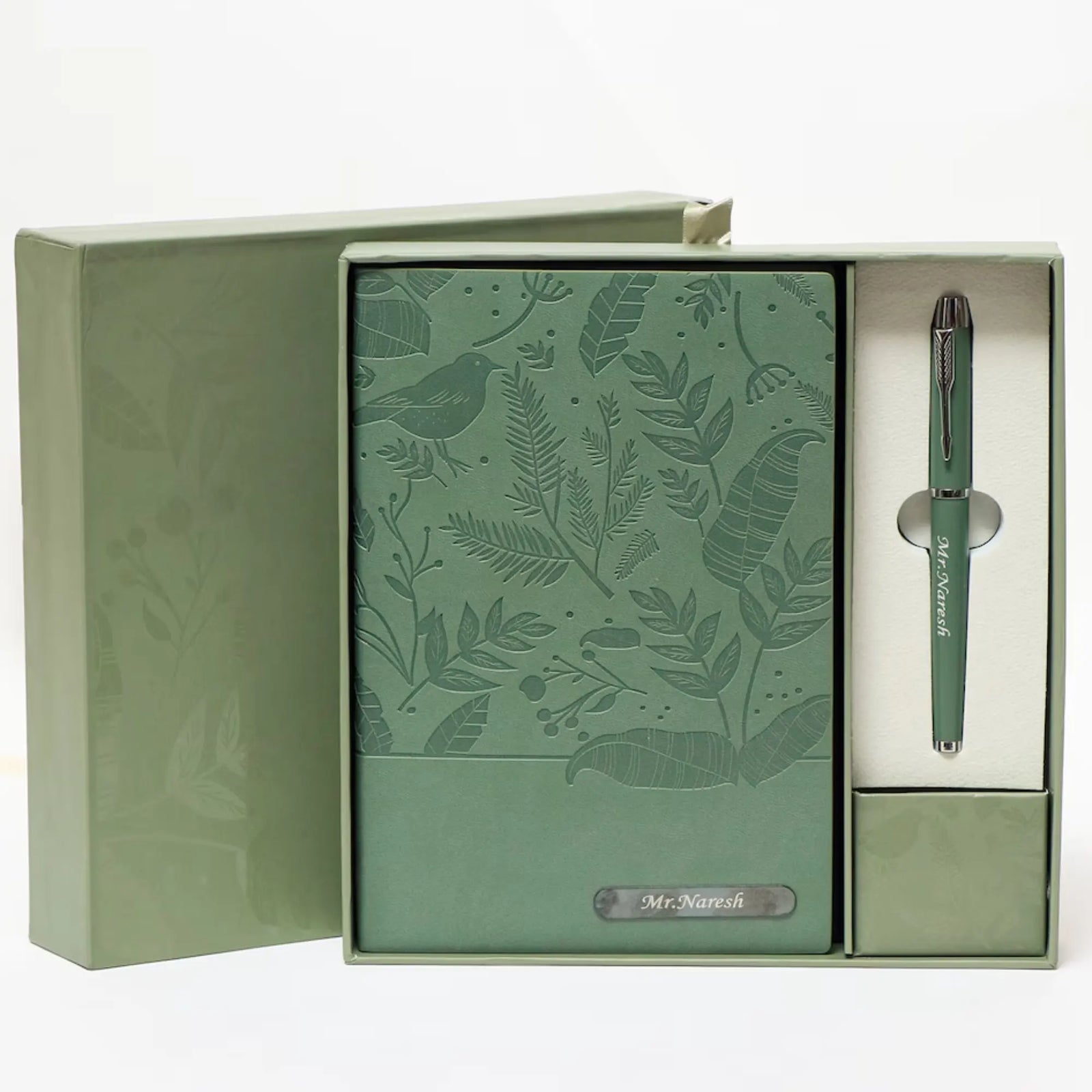 Green notebook and pen set with floral design in a box